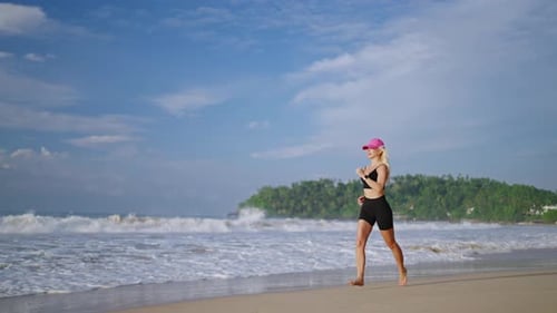 Young Blonde Woman Jogs By Sea at Sunrise Caucasian Female Runs on Beach By Ocean at Dusk Fit Sporty