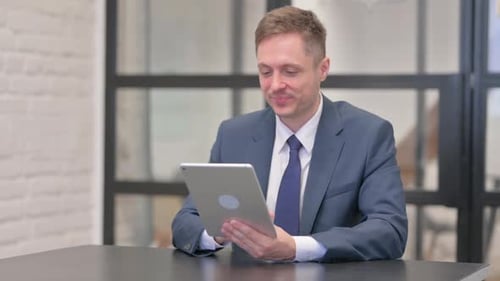 Young Businessman Doing Video Chat on Tablet in Office