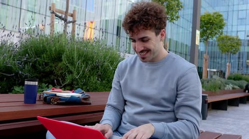 Young Happy Student Man Using Laptop at University Campus