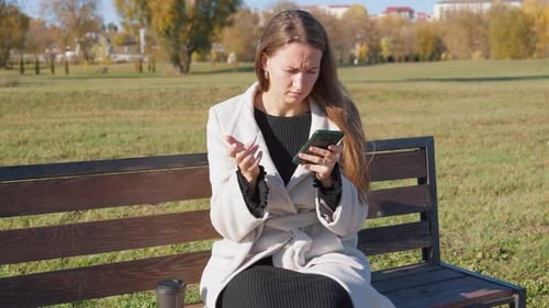 Female tourist in straw shyap at resort choosing and buying clothes at market