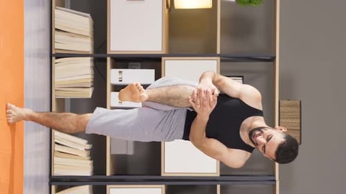 Man Doing Yoga Leg Stretch at Home