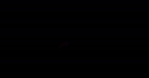 Ignite Collection: Brief expel of a short fireball from left to right in center on dark background,