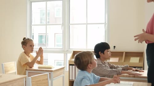 Diverse smart student raised hands to answer question at classroom. Pedagogy.