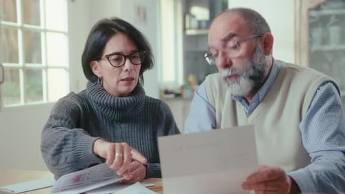 Couple Discussing Finances at Home Together