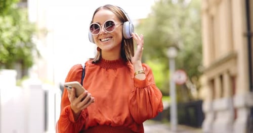 Music headphones, phone and woman dancing in city, having fun or happiness outdoor