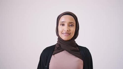 Smiling Woman Wearing a Traditional Headscarf