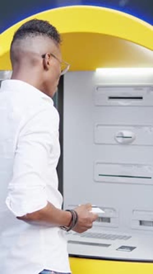 Man Withdrawing Money From the ATM