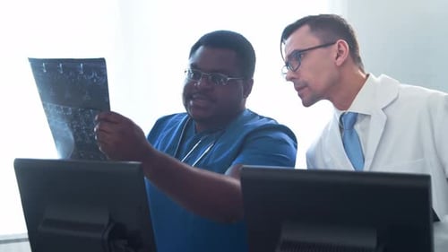Doctor and Surgeon Talking Near Window Medical Workers in Hospital Office Day Light Healthcare