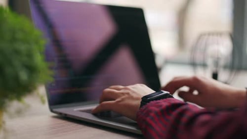 Nahaufnahme von Freelancers Händen, die Code auf der Laptop-Tastatur eingeben, rutscht um die des Entwicklers