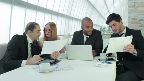 Colleagues Discuss Business Around Office Table