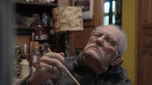 Senior Artist on a Wheelchair Paints an Oil Painting on Canvas in a Studio