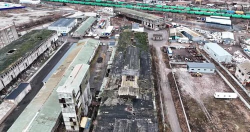 Desolate industrial area with old plant constructions. Large plant territory devastated by time.