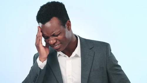 Headache, studio face and professional black man with head pain, medical emergency