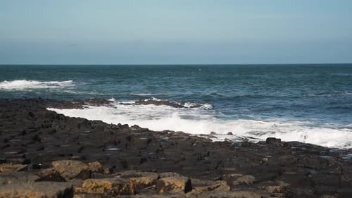 Wide angle view looking out from Giant's Causeway to sea, slow motion