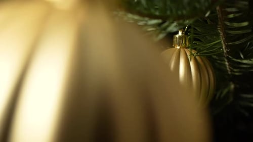 Gold Christmas Ornaments Hanging on a Tree