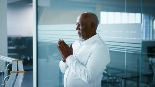 Businessman Reflecting in a Modern Office Space During a Productive Workday