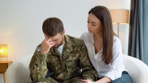 Depressed Soldier Talking to Therapist While They Sitting on Sofa During Therapy at Office