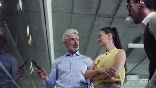 Diverse business team brainstorming ideas together in a bright modern office