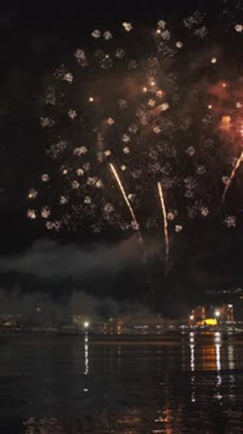 Fireworks with colorful lights over sea