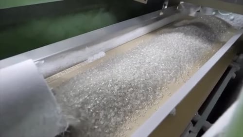 Conveyor Belt Transporting Clear Objects in Factory