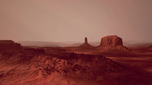Aerial View of a Mesmerizing Desert Landscape with a Majestic Rock Formation