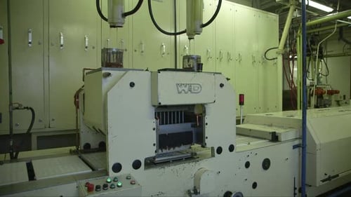 molds are filled with chocolate in a chocolate factory