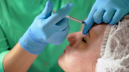 Adult Receiving Forehead Injection at Medical Clinic