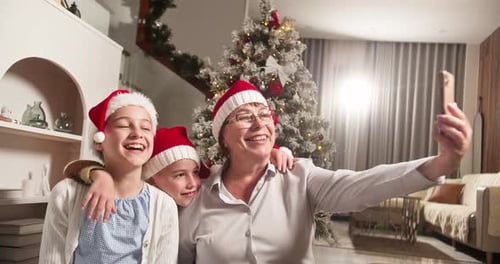 Grandmother and Children Taking Christmas Selfie