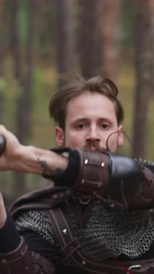 Man in Armor Wields Sword in Forest Fencing