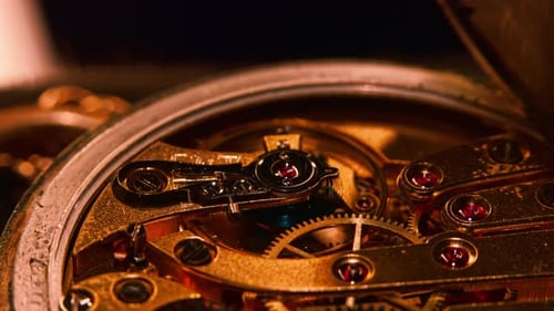 Mechanism and gears of an old pocket watch. Macro close up shot. Multiple layers of gears, camera mo