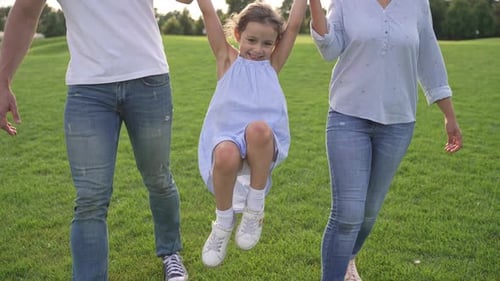 Family Enjoying Happy Summer Day in the Park