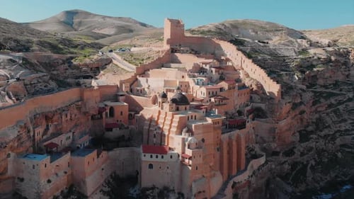 Mar Saba Monastery, a cinematic drone flying backwards shot, temple built into the mountain, Israel.