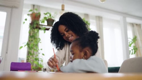 Mother and Daughter Having Fun Drawing Together at Home