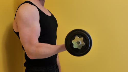 Man Working Out with Dumbbell Curls in Home