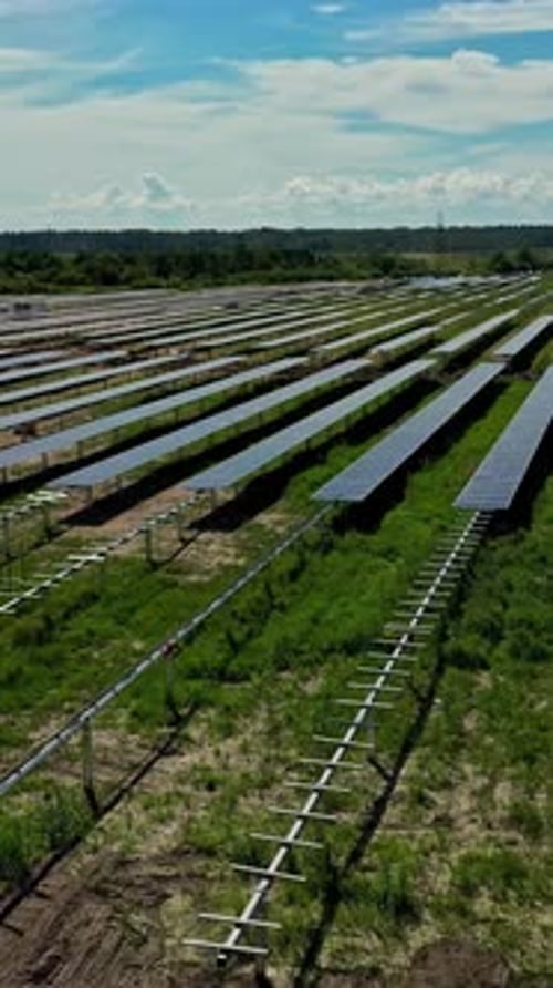 solar farm with rows of panels in rural landscape