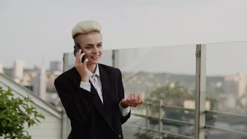Closeup of Attractive Young Businesswoman Standing on the Balcony of a Beautiful Office in the City