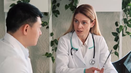 Doctors Discussing X-Ray in Medical Office