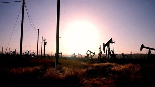 Oil Derricks Pumping in the Golden Sunrise Light