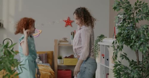 Mother and Child Happily Dancing Together at Home