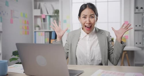 businesswoman crazy with overworked stress angry massive work scream at office.