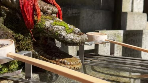 Close-up of water basin for purification in Fushimi Inari Taisha Kyoto Japan.