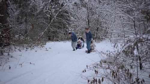 Parents and Children Have Fun Sledding Family Concept