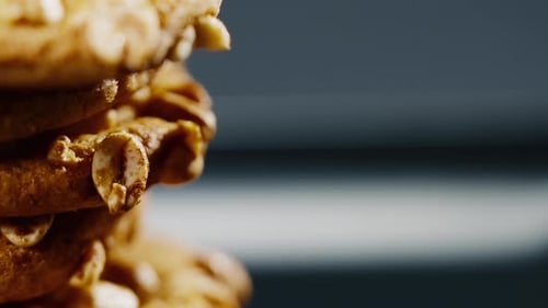 Close Up on Black and Blue Background Flat Plate with Cookie Cookies Built in a Pyramid Sweet
