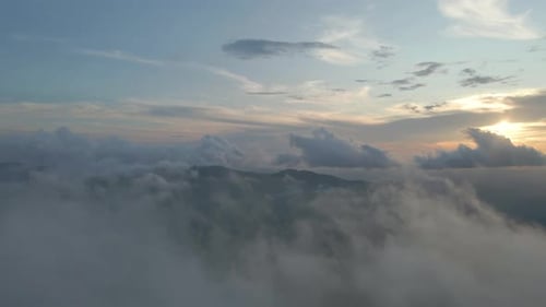 sunset through the clouds. Flying heavenly beautiful sunny cloudscape. Amazing golden fluffy on the