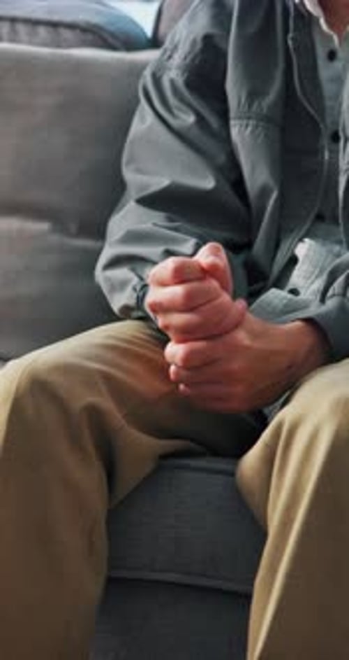 Close Up of Interlocked Hands on a Sofa