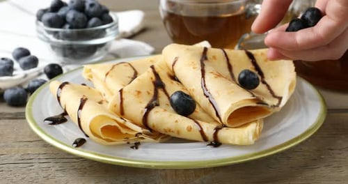Adding Blueberries to Chocolate Drizzled Crepes, Breakfast
