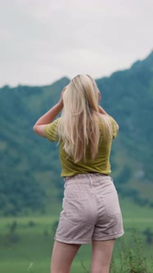 Female Tourist Adjusts Shorts and Shakes Hair at Eco Reserve