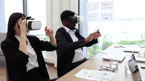 Coworkers Using VR Headsets in Office Environment