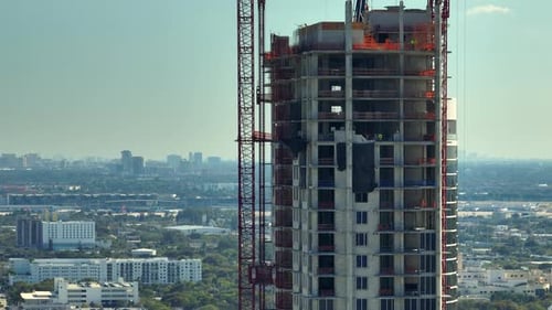 Tower Lifting Cranes at High Residential Apartment Building Construction Site Real Estate