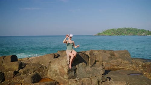 Woman Using VR Headset on Tropical Rocky Coast